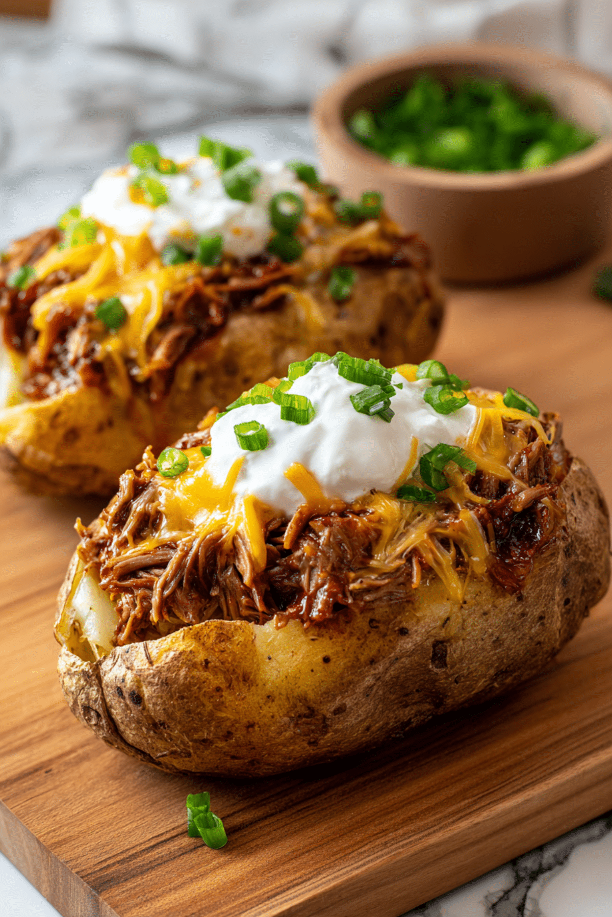 Bang Bang Shredded Beef Loaded Baked Potatoes